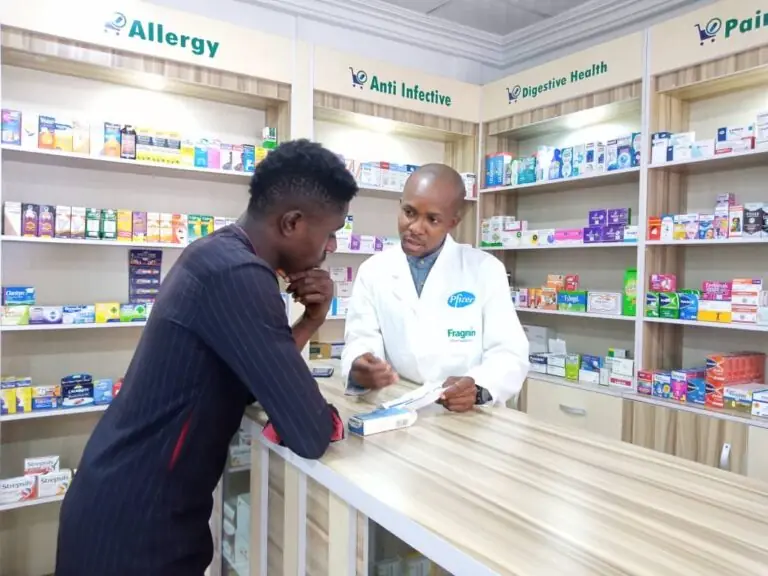 A Primacare pharmacist advising a customer at the pharmacy counter